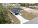 Picture of a single-Gathering home boasting a dark roof, a lengthy driveway, and a sizable, grassy front yard at 16890 Sw 39Th Cir, Ocala, FL 34473