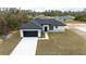 Beautiful single-story home boasts a dark garage, complementary black roof, and a well-manicured lawn at 16890 Sw 39Th Cir, Ocala, FL 34473