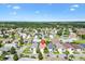Aerial view pinpointing the home within a scenic community surrounded by lush greenery and palm trees at 1736 Watts Mill Way, The Villages, FL 32162