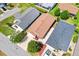 An aerial perspective of a home, showcasing its landscaping, roofing, driveway and neighborhood at 1736 Watts Mill Way, The Villages, FL 32162