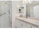 Bright bathroom featuring walk-in shower with glass doors and neutral-colored countertops at 1736 Watts Mill Way, The Villages, FL 32162