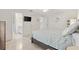 Comfortable bedroom leading to bathroom and featuring tile floors and ceiling fan at 1736 Watts Mill Way, The Villages, FL 32162