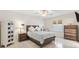 Cozy bedroom featuring a ceiling fan, shutters and neutral-colored furnishings at 1736 Watts Mill Way, The Villages, FL 32162