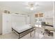This bedroom features a murphy bed, granite-topped desk, and neutral tile flooring for a versatile living space at 1736 Watts Mill Way, The Villages, FL 32162