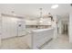 Bright kitchen features tiled bar, white cabinetry and stainless steel appliances at 1736 Watts Mill Way, The Villages, FL 32162
