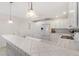 Bright kitchen featuring tiled countertops, white cabinetry and adjacent breakfast bar at 1736 Watts Mill Way, The Villages, FL 32162