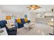 Bright living area with easy access to kitchen, tile floors, and comfortable furnishings at 1736 Watts Mill Way, The Villages, FL 32162