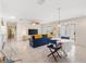 Bright living room featuring tile floors, a ceiling fan, and sliding glass doors for natural light at 1736 Watts Mill Way, The Villages, FL 32162