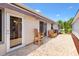 Inviting covered patio with pavers, canvas awning, and chairs for outdoor relaxation and entertaining at 1736 Watts Mill Way, The Villages, FL 32162