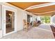 Inviting covered patio with stylish pavers, an awning, and comfortable seating area perfect for outdoor relaxation at 1736 Watts Mill Way, The Villages, FL 32162