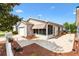 Charming home featuring a paved patio, screened-in porch, manicured landscaping, and a white picket fence at 1736 Watts Mill Way, The Villages, FL 32162