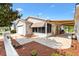 Charming rear exterior showcasing a paved patio area, a canvas awning, screened-in porch, and meticulous landscaping at 1736 Watts Mill Way, The Villages, FL 32162
