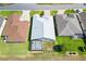Aerial view showcasing the home's layout, backyard with screened lanai, landscaping, and neighborhood at 17902 Se 115Th Cir, Summerfield, FL 34491