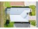 Aerial view of the property, featuring the roof, screened lanai, landscaping, and surrounding homes at 17902 Se 115Th Cir, Summerfield, FL 34491