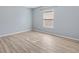 Light-filled bedroom features light wood floors and a large window allowing ample natural light at 17902 Se 115Th Cir, Summerfield, FL 34491