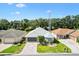 Aerial of home with well-maintained landscaping, paver driveway, and mature trees at 17902 Se 115Th Cir, Summerfield, FL 34491