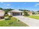 Charming home showcasing a paver driveway, well-manicured lawn, and mature landscaping at 17902 Se 115Th Cir, Summerfield, FL 34491