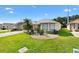 Well-maintained front yard with mature landscaping and a paver driveway, providing curb appeal at 17902 Se 115Th Cir, Summerfield, FL 34491