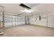 Spacious garage with ample storage and a roll-up door, offering functionality and convenience at 17902 Se 115Th Cir, Summerfield, FL 34491