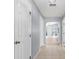 Hallway with tile flooring leads into a bright living area, with multiple entry ways at 17902 Se 115Th Cir, Summerfield, FL 34491