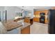 Open kitchen with granite countertops, a breakfast bar, and stainless steel appliances at 17902 Se 115Th Cir, Summerfield, FL 34491