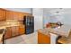 Kitchen featuring wooden cabinets, stainless steel appliances, granite counter tops and tile flooring at 17902 Se 115Th Cir, Summerfield, FL 34491