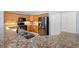 Close-up of a kitchen showcasing granite countertops, stainless steel appliances, and wooden cabinetry at 17902 Se 115Th Cir, Summerfield, FL 34491