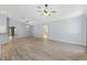 Open-concept living room featuring wood-look floors, arched doorways, and bright neutral paint at 17902 Se 115Th Cir, Summerfield, FL 34491