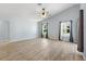 Neutral living room featuring wood-look floors, vaulted ceilings, and ample natural light at 17902 Se 115Th Cir, Summerfield, FL 34491