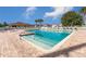 Bright and inviting community pool featuring a brick deck, clear water, and ample seating at 17902 Se 115Th Cir, Summerfield, FL 34491