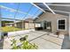 Covered, screened lanai offering an outdoor living space with ceiling fan, overlooking the backyard at 17902 Se 115Th Cir, Summerfield, FL 34491