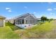 Exterior view showing the screened lanai and lush backyard of the property, perfect for outdoor enjoyment at 17902 Se 115Th Cir, Summerfield, FL 34491