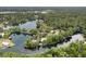 Breathtaking aerial view of a home nestled on a private lake peninsula amidst lush greenery at 19938 Burkitt Rd, Dunnellon, FL 34432