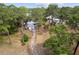 An aerial view of a cozy single-story home and the lush surrounding landscape at 19938 Burkitt Rd, Dunnellon, FL 34432