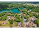 Picturesque aerial view of lakefront homes surrounded by lush greenery and clear blue waters at 19938 Burkitt Rd, Dunnellon, FL 34432