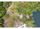 Aerial view of lakefront property featuring the home and direct access to the water at 19938 Burkitt Rd, Dunnellon, FL 34432