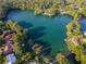 Beautiful aerial view of lake and surrounding landscape with clear turquoise water near residential area at 19938 Burkitt Rd, Dunnellon, FL 34432