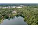 A sprawling, lake-front property with a dock, surrounded by lush greenery at 19938 Burkitt Rd, Dunnellon, FL 34432