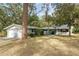 Charming single-story home featuring a two-car garage and mature trees in a serene setting at 19938 Burkitt Rd, Dunnellon, FL 34432