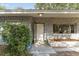 Charming front entrance featuring a stone facade, complemented by lush greenery and a secure entry at 19938 Burkitt Rd, Dunnellon, FL 34432