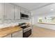 Kitchen featuring stainless steel appliances, butcher block countertops, and shaker style cabinets at 19938 Burkitt Rd, Dunnellon, FL 34432