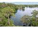 Scenic aerial view of a serene lake surrounded by lush greenery at 19938 Burkitt Rd, Dunnellon, FL 34432