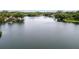 Expansive view of lake with a home and dock among lush trees at 19938 Burkitt Rd, Dunnellon, FL 34432