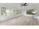 Sunroom with white walls, vinyl floors, lots of windows, and fan at 19938 Burkitt Rd, Dunnellon, FL 34432