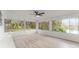 Sunroom with white walls, vinyl floors, and lots of windows at 19938 Burkitt Rd, Dunnellon, FL 34432