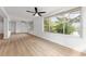 Spacious, light-filled living room with hardwood floors and windows offering picturesque outdoor views at 19938 Burkitt Rd, Dunnellon, FL 34432