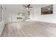 Sunroom with white walls, vinyl floors, lots of windows, and fan at 19938 Burkitt Rd, Dunnellon, FL 34432