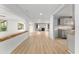Open concept living room with hardwood floors leading to kitchen with gray cabinets and wooden countertop at 19938 Burkitt Rd, Dunnellon, FL 34432