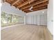 Large room with rustic wood ceiling, lots of windows, and wood floors at 19938 Burkitt Rd, Dunnellon, FL 34432