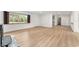Bright living room featuring light wood floors and expansive windows with backyard views at 19938 Burkitt Rd, Dunnellon, FL 34432